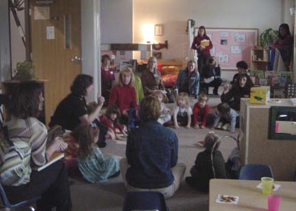 The room darkens, candles are lit. As  children particpate in Godly Play  participants move to the side to unobtrusively observe this special time. 